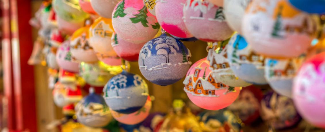 Colourful round Christmas ornaments depicting various winter scenery