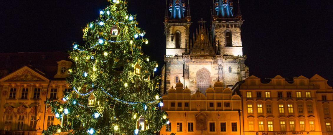 A decorated Christmas tree in front of Church of Our Lady at a Christmas market in Old Town Square, Prague, Czech Republic