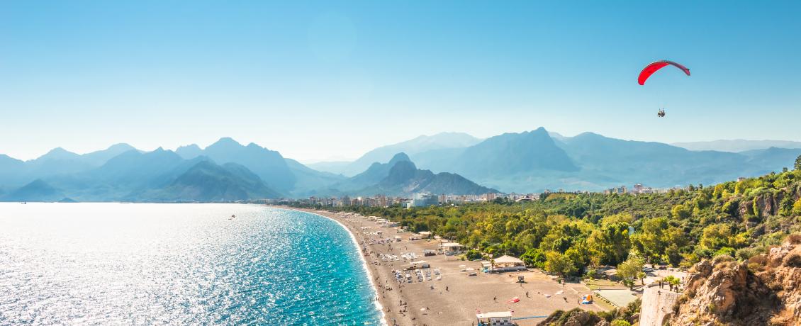 Panoramic bird view of Antalya beach with a paraglider