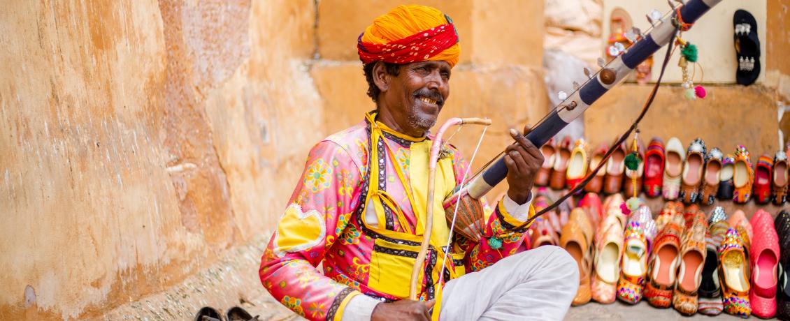 Rajasthani folk music performer siting holding an instrument