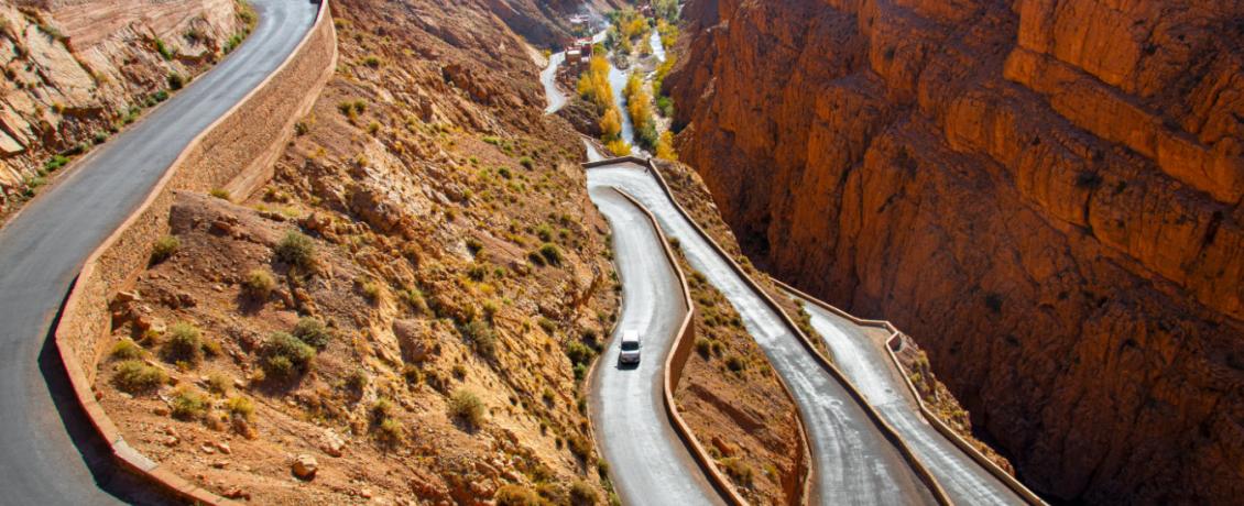 Car driving along the winding Dades Valley