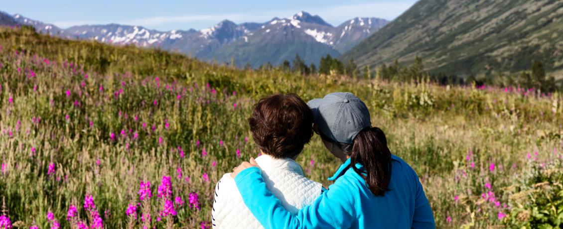 Ladies embracing in the Alaskan Mountains