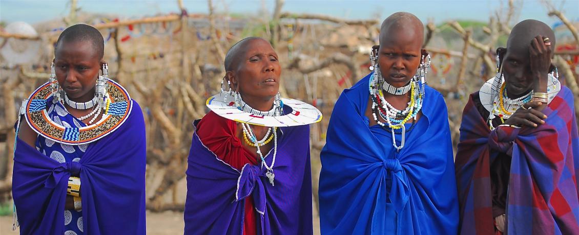 Maasai women adorned in vibrant, colorful garments 