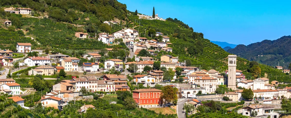 A small town on a hilltop surrounded by vineyards in Conegliano, Italy