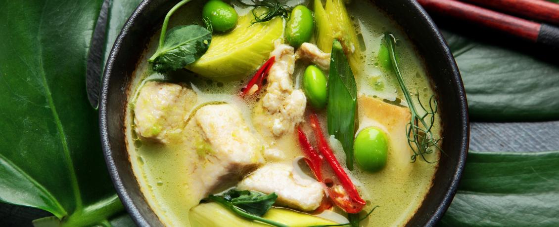 Green curry with chicken in bowl