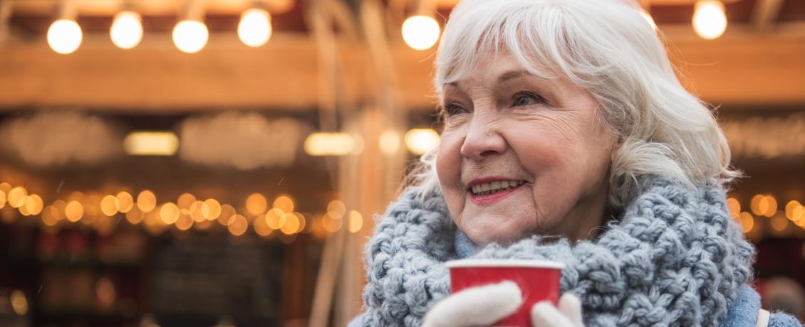 Woman holding a cup in a Christmas market
