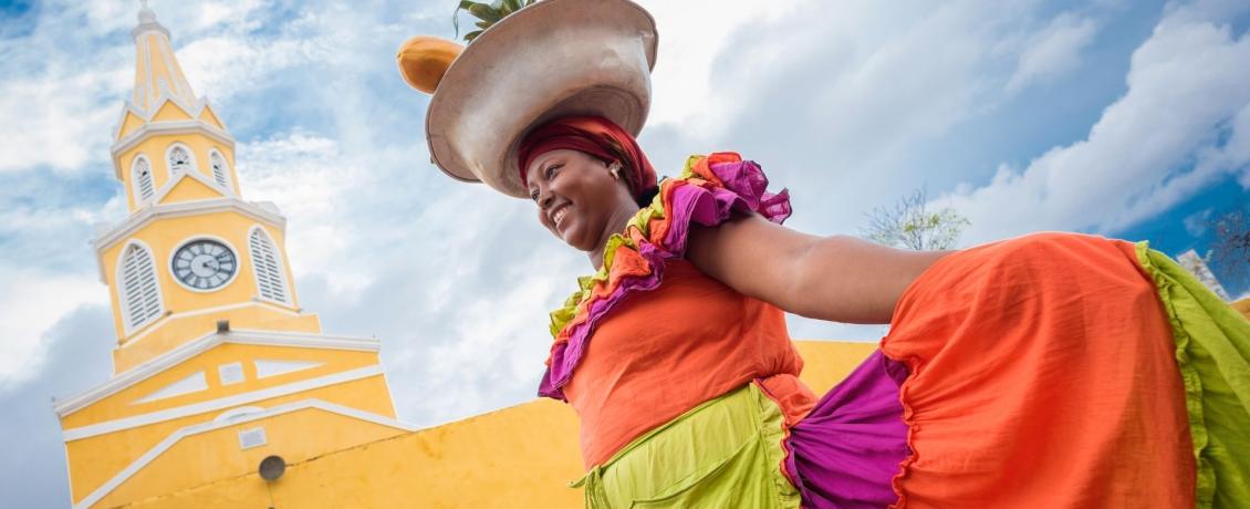 Happy palenquera selling fruit in Cartagena