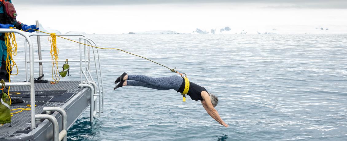 Guest diving into icy waters during polar plunge