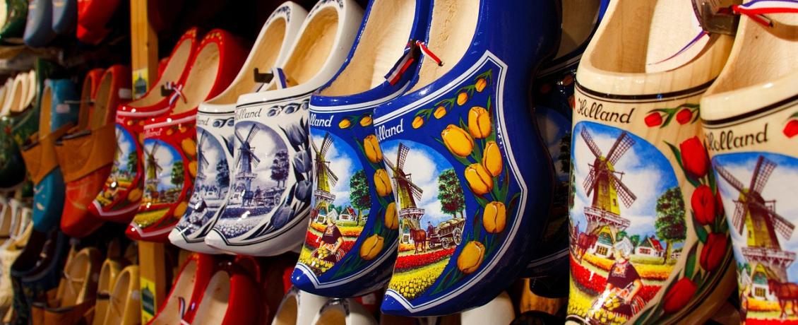 Traditional Dutch wooden clogs painted with tulips and windmills displayed in a souvenir shop