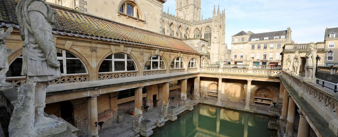 The Roman Baths in Bath, England, with the ancient pool and surrounding colonnades.